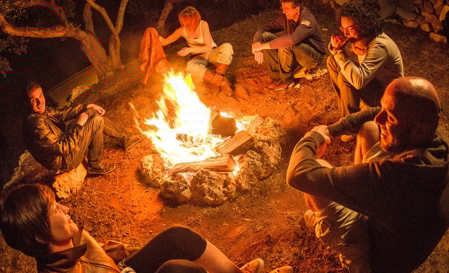 Campfire of friends in circle on the fire
